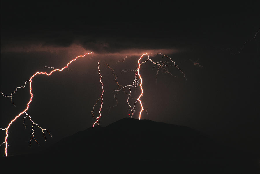 Dark Clouds Release Bright Pink Branching Lightning Bolts To The Ground Blow Photograph by Photodisc