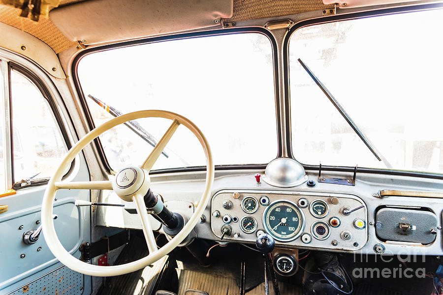 Dashboard and steering wheel of an old retro American van still in use. Photograph by Joaquin Corbalan