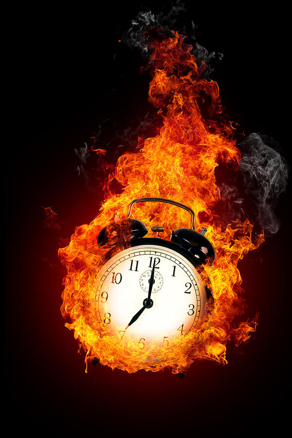 Deadline concept. Burning alarm clock. Photograph by Sankai