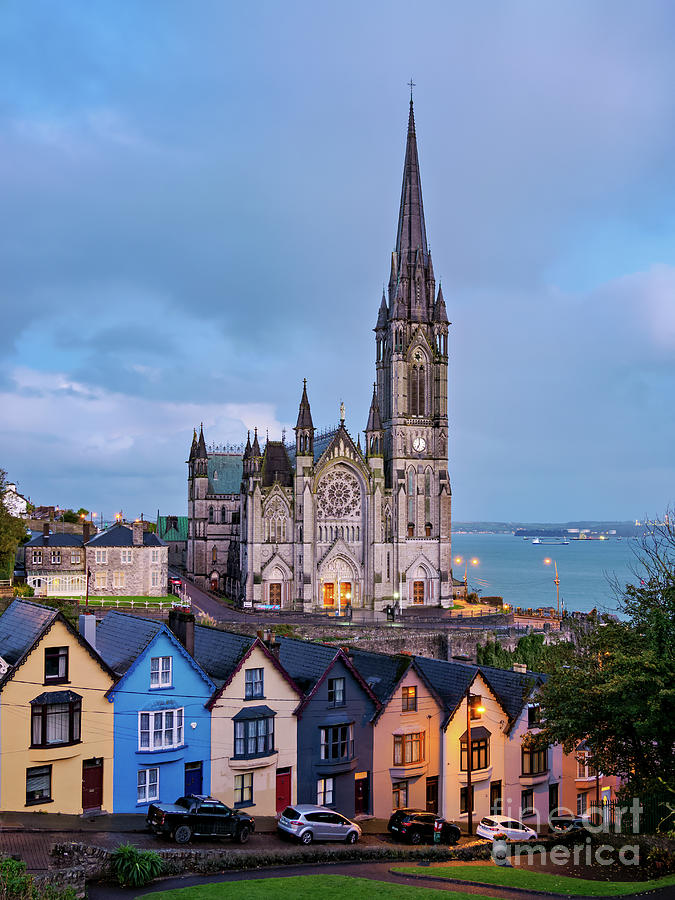 Deck of Cards colourful houses and St. Colman's Cathedral at dusk in ...