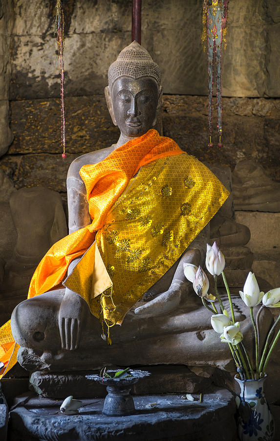 Decorated Buddha statue with flowers in temple Photograph by John D. Buffington