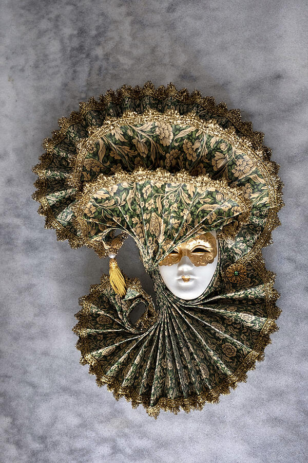 Decorative Venetian mask on gray tableto. Photograph by Emreturanphoto