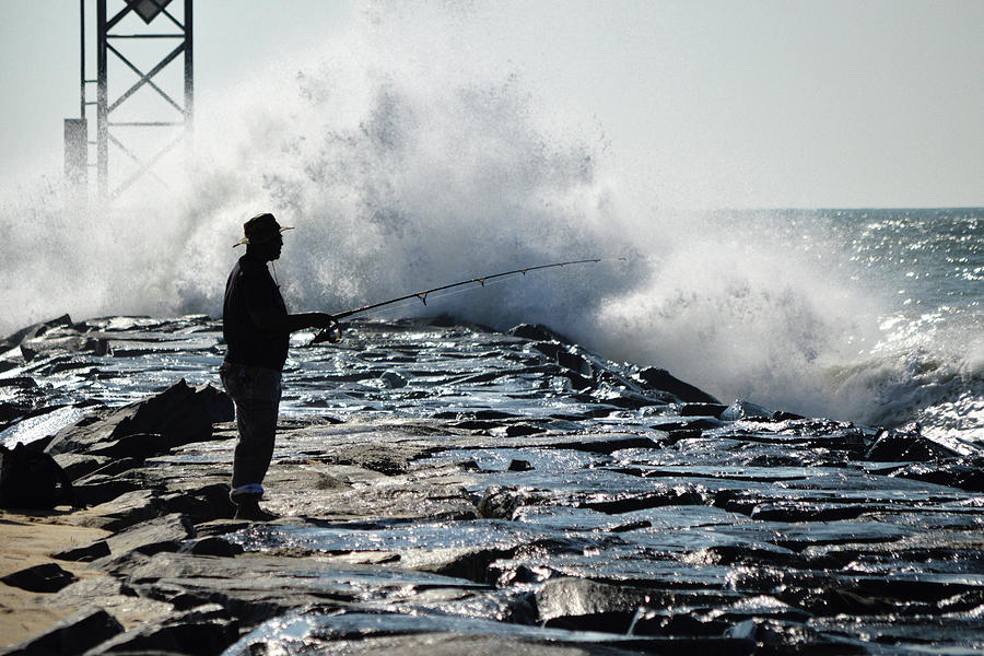 Dedicated Fisherman at the Ocean City Inlet Photograph by Bill Swartwout