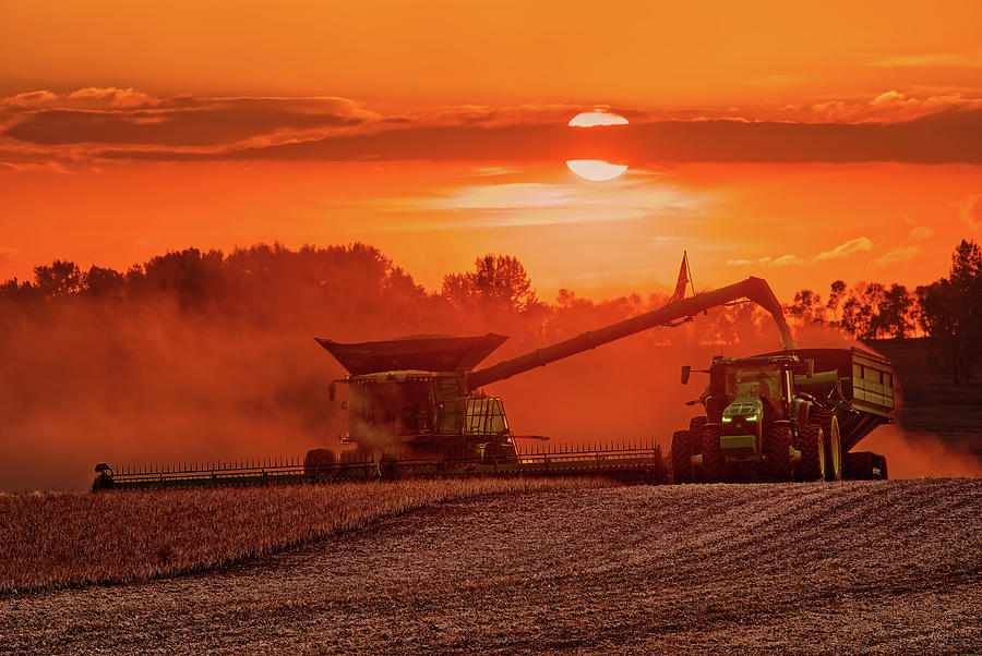 Deere in their Natural Habitat -  John Deer combine, tractor and cart harvesting beans in ND Photograph by Peter Herman