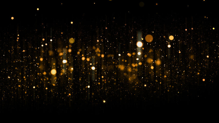 Defocused Golden Particles Glittery against Dark Background with Copy Space. Christmas Overlay Photograph by Fotograzia