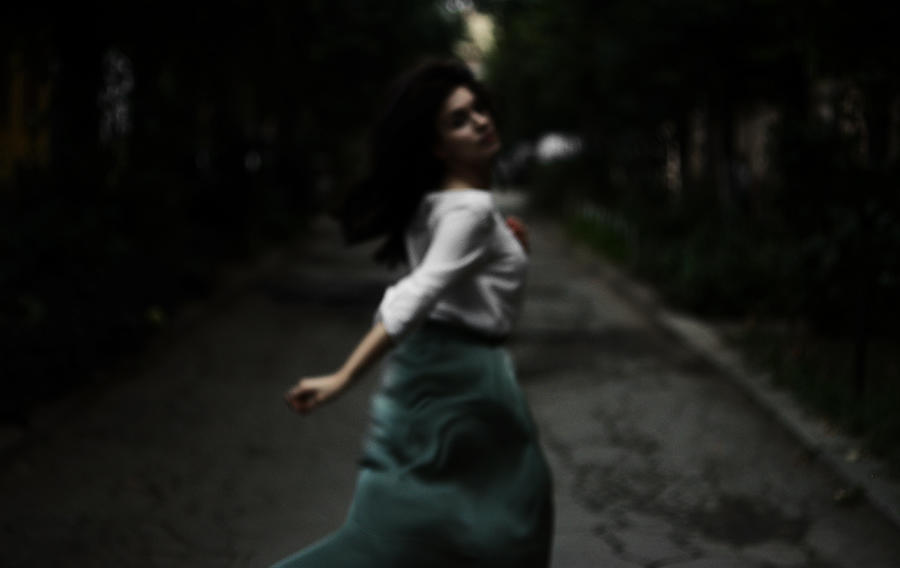 Defocused photo of woman running on the street Photograph by Igor Ustynskyy