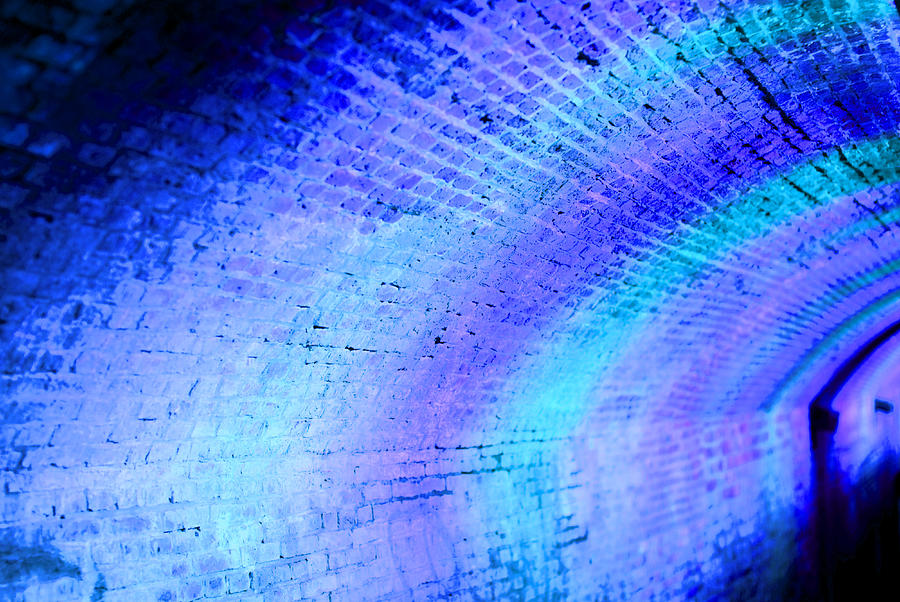Defocussed blue and purple lights at night in tunnel Photograph by Lyn Holly Coorg