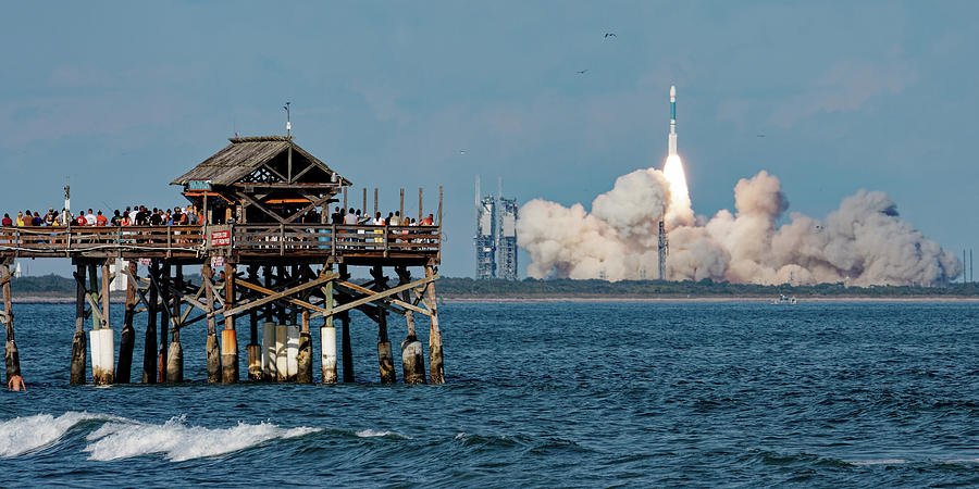 Delta II and the Cocoa Beach Pier Photograph by Ron Dubin