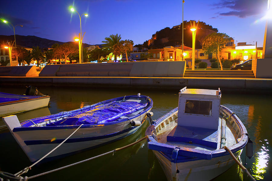 Denia port marina with traditional llaut boats at sunset night Photograph by Lunamarina