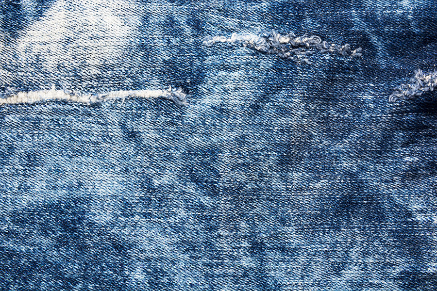 Denim texture. Blue jeans with threads and holes Photograph by Julien ...