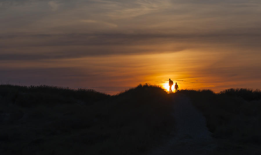 Denmark, Jutland, Lokken, mother and daughter walking in dune at sunset Photograph by Westend61