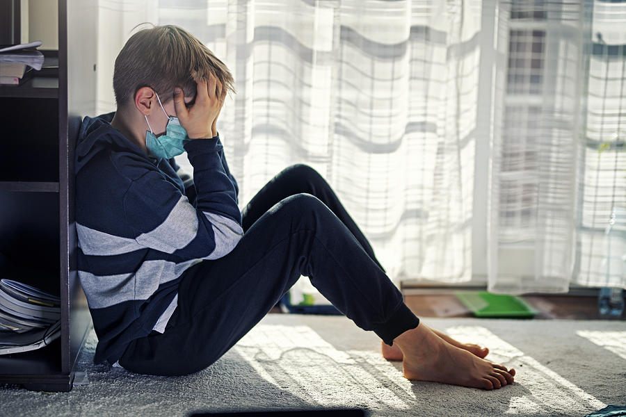 Depressed kid during epidemic quarantine Photograph by Imgorthand