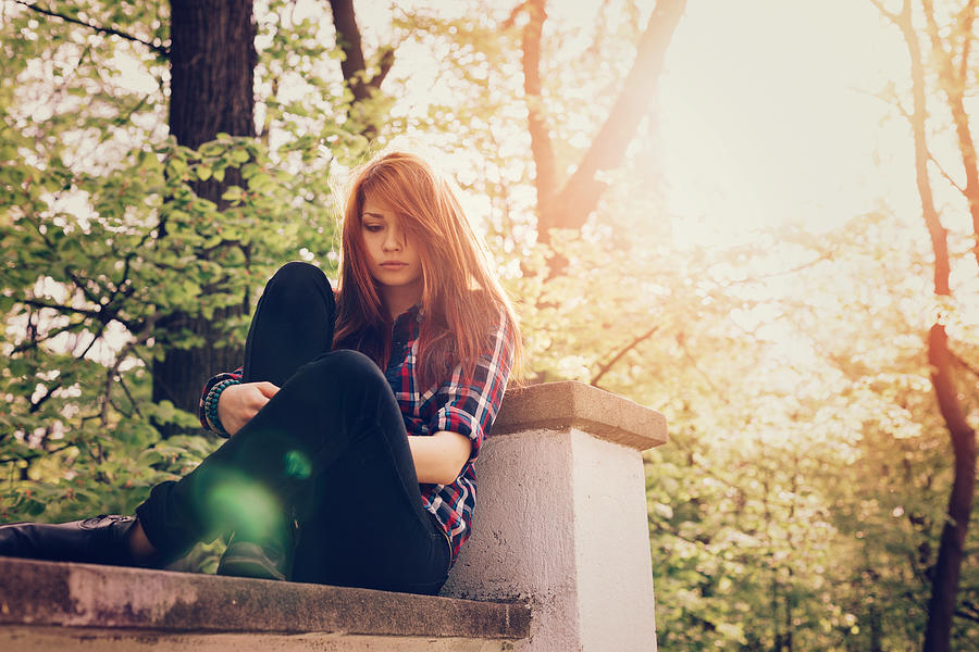 Depressed teenage girl outside Photograph by Martin-dm