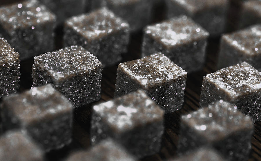 Desaturated brown sugar cubes in row by Benedek Alpar