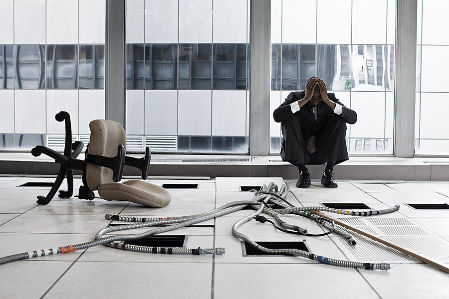 Despairing businessman in abandoned office Photograph by Image Source