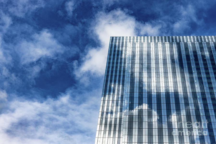 Detail of a generic modern glass building reflect the clouds of  Photograph by Jane Rix