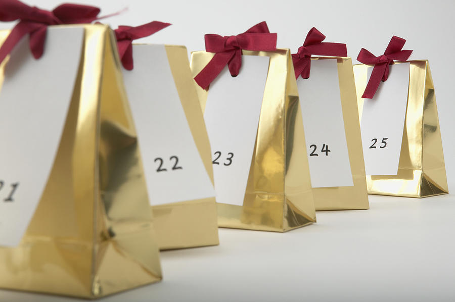 Detail view of a row of Christmas presents labeled with the numbers 21 to 25 Photograph by Corbis/VCG