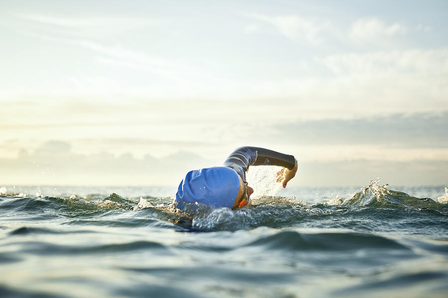 Determined woman swimming in sea Photograph by Morsa Images