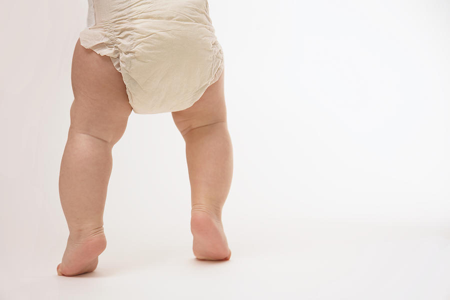 Diapered babys legs. Photograph by Rebekah Logan