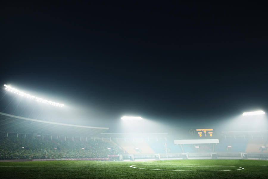 Digital coposit of soccer field and night sky Photograph by XiXinXing