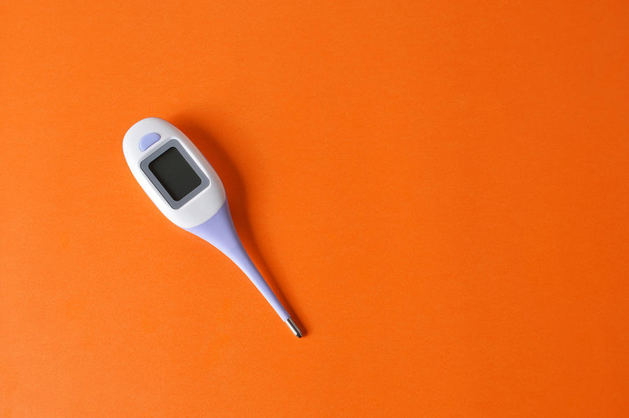 Digital Medical Thermometer on the Orange Color Background with Copy Space Photograph by S-cphoto