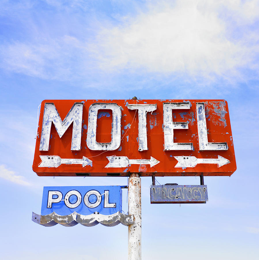 Dilapidated motel neon sign under blue sky Photograph by Jacobs Stock Photography Ltd