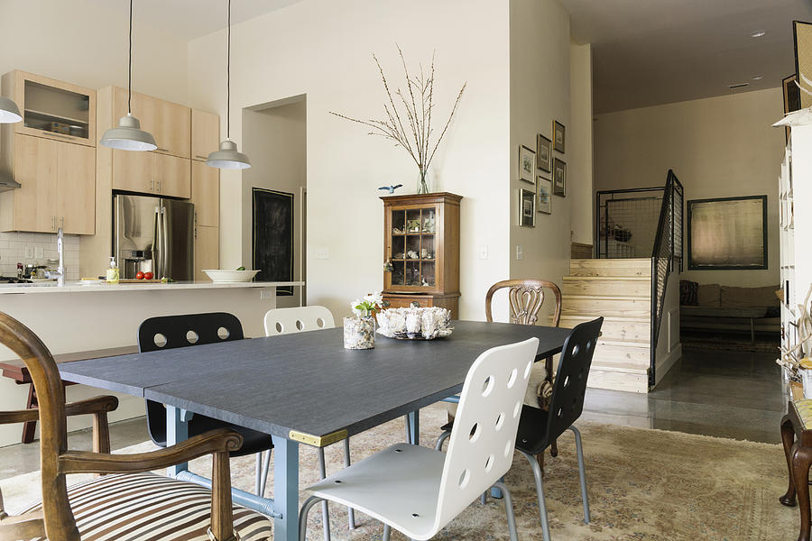 Dining table and chairs in modern living space Photograph by Roberto Westbrook