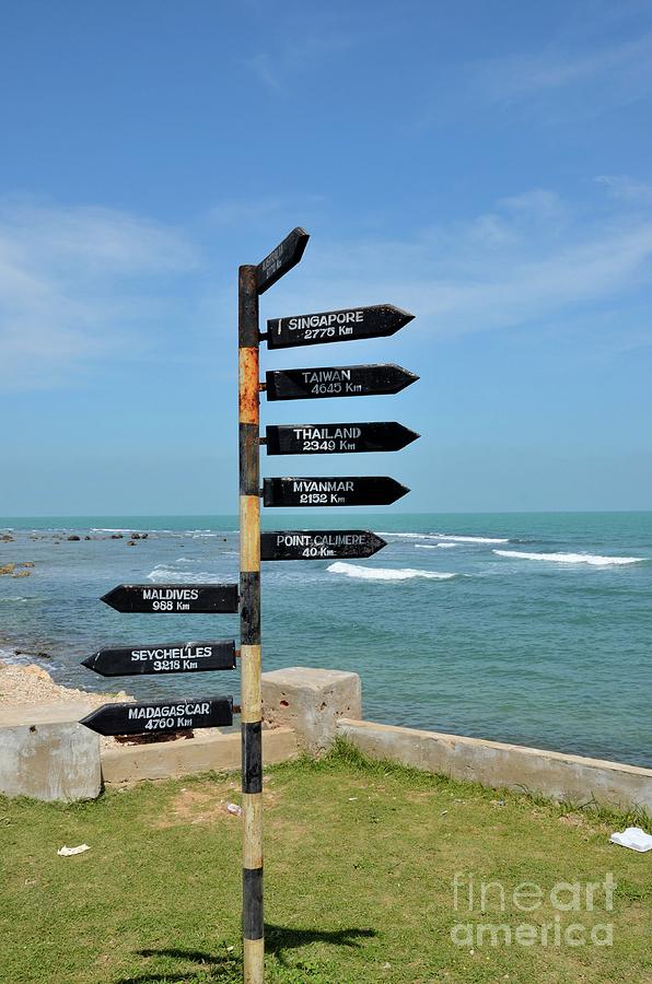 Directional distance arrows with kilometers to Australia Singapore at beach in Jaffna Sri Lanka Photograph by Imran Ahmed