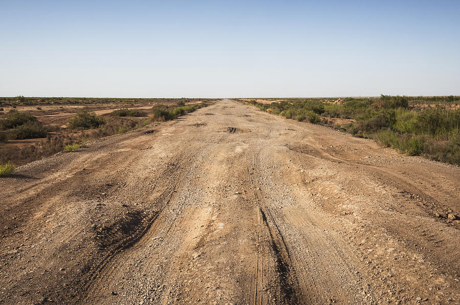 Dirt road across the desert in Turkmenistan, Central Asia Photograph by Jean-Philippe Tournut