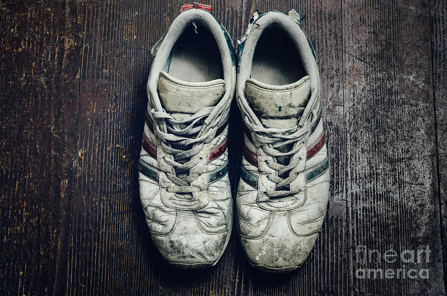 Dirty old shoes on wooden floor Photograph by Jelena Jovanovic