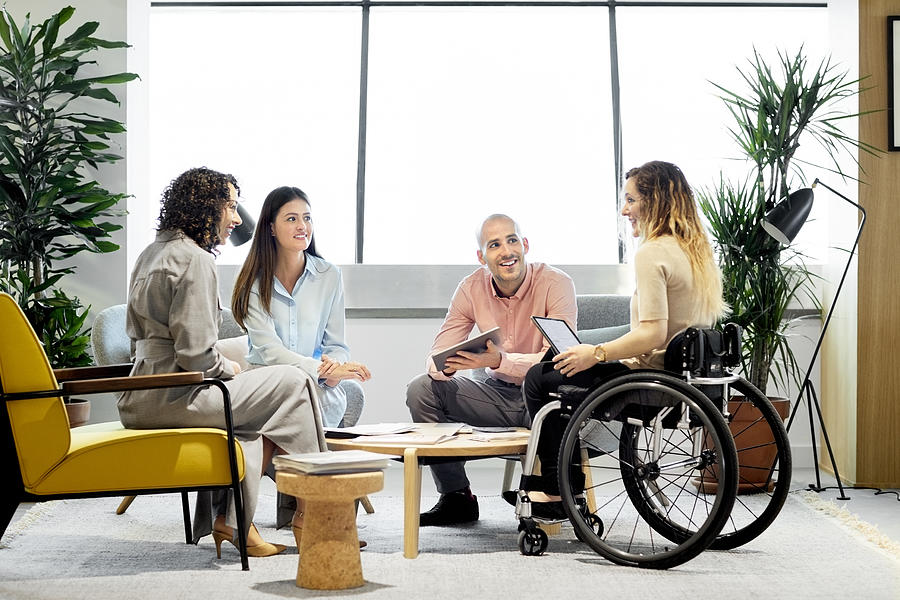 Disabled professional with coworkers in meeting Photograph by Morsa Images