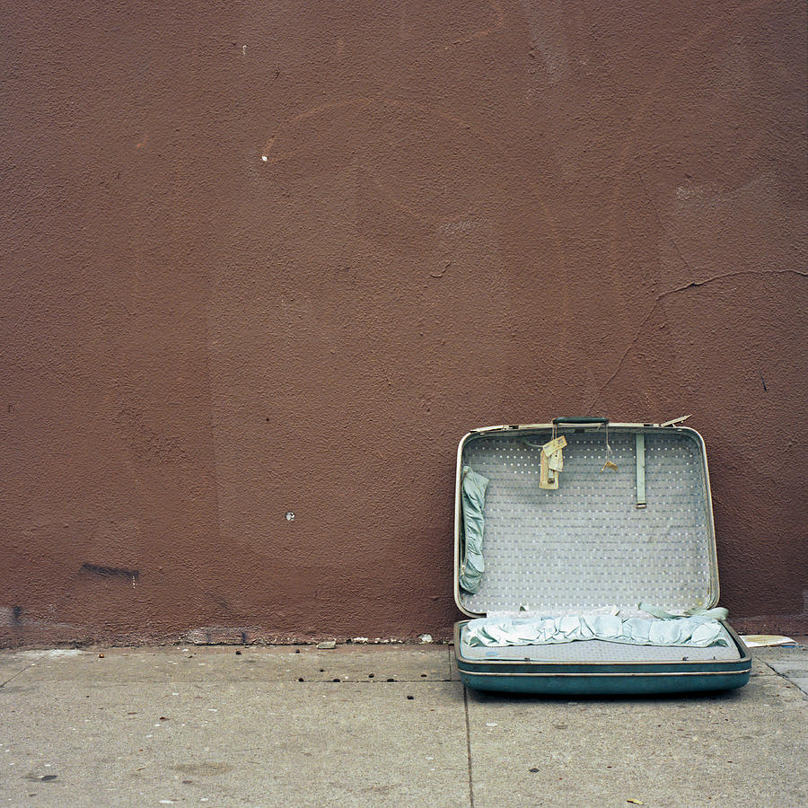 Discarded suitcase on sidewalk Photograph by Studio 642