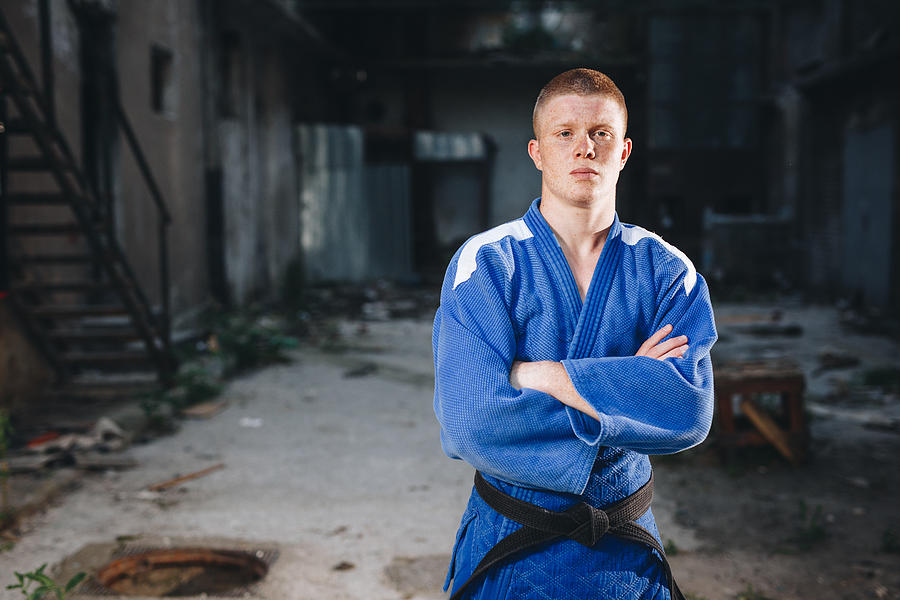 Disciplined judo practitioner in a blue kimono Photograph by FluxFactory