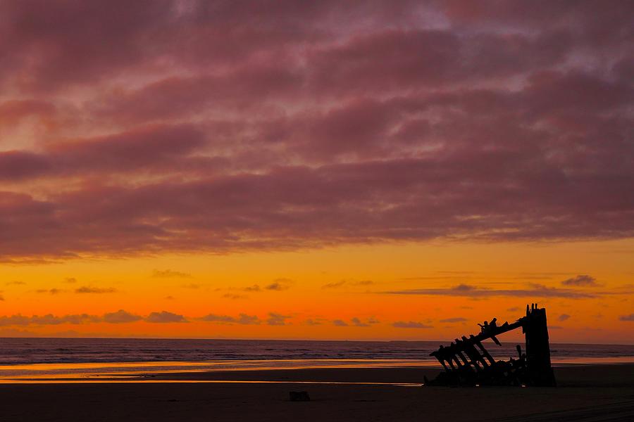 Distant shot of the ship Peter Iredale at sunset Photograph by Brent Bunch