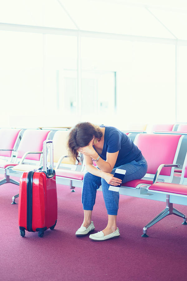 Distraught Woman stuck at airport Photograph by Pawel Gaul