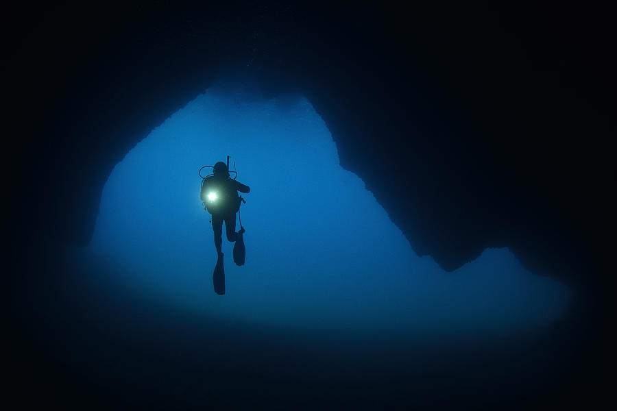 Diver Exploring An Undersea Cave. Photograph by Humberto Ramirez