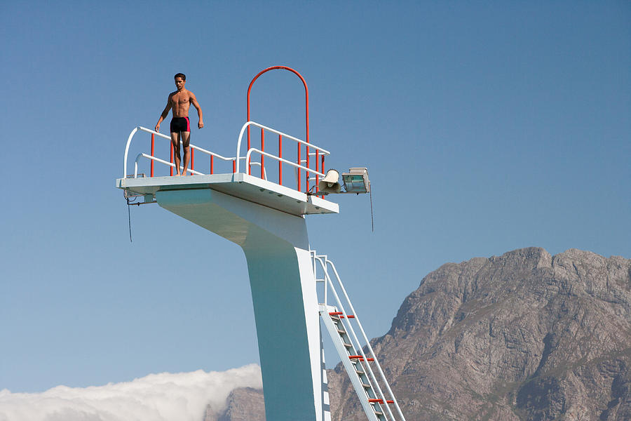 Diver standing on a diving board in a scenic location Photograph by Chris Ryan