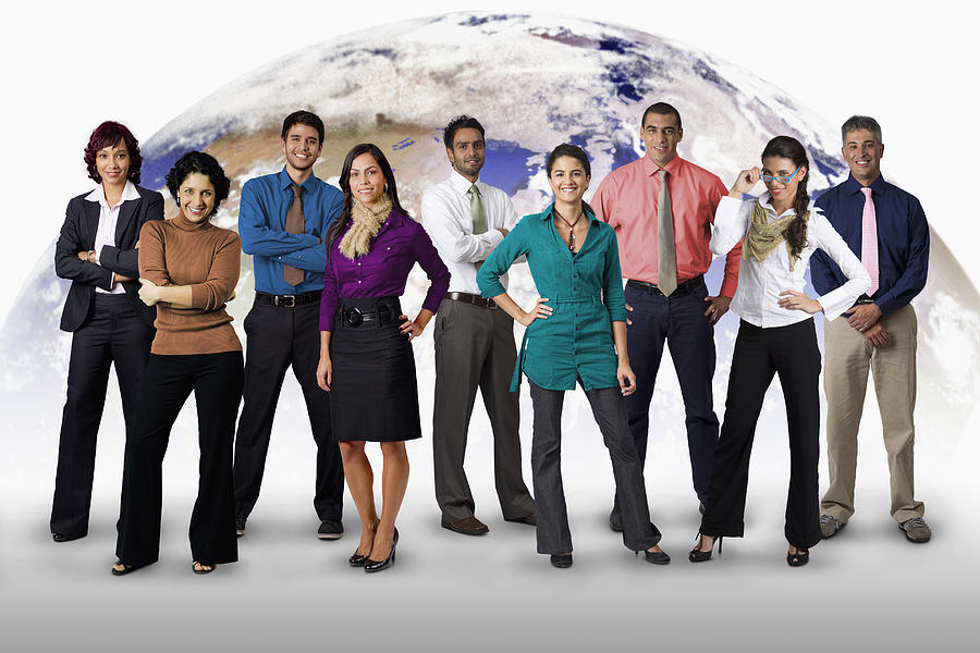 Diverse business people standing together with globe in background Photograph by Jon Feingersh Photography Inc