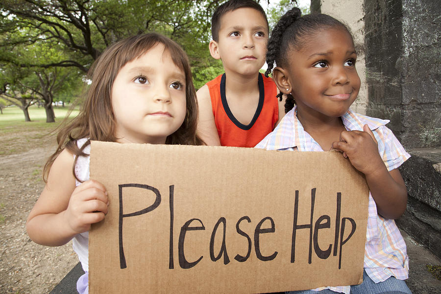 Diverse Group of Children Holding a Please Help Sign Photograph by SDI Productions