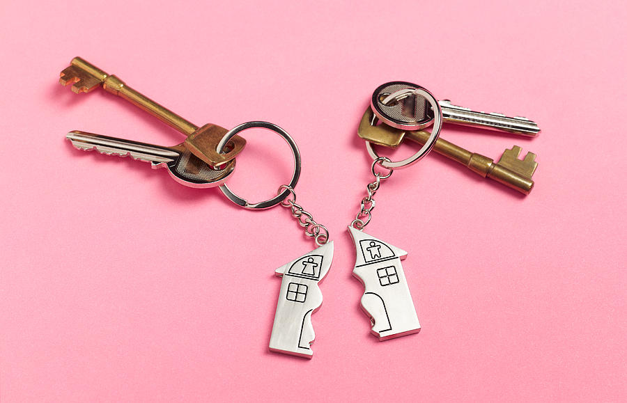 Divorce house keys on pink Photograph by Peter Dazeley