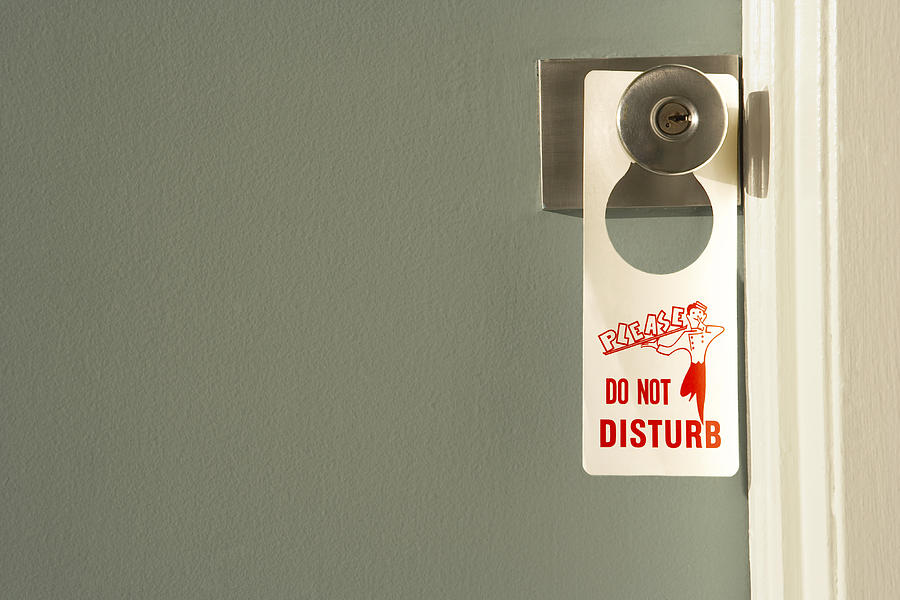 Do Not Disturb sign on doorknob, close-up Photograph by Alan Powdrill Do Not Disturb sign on doorknob, close-up Photograph by Alan Powdrill
