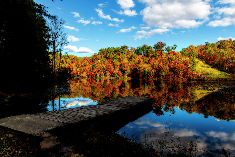 Dock at lake in the Fall Photograph by Dan Friend