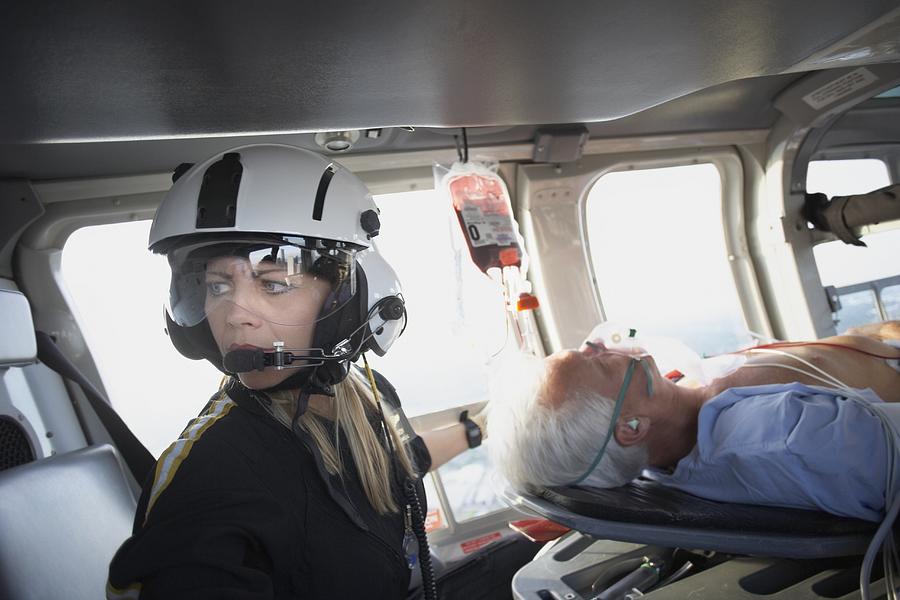 Doctor and patient in medical helicopter Photograph by ER Productions Limited