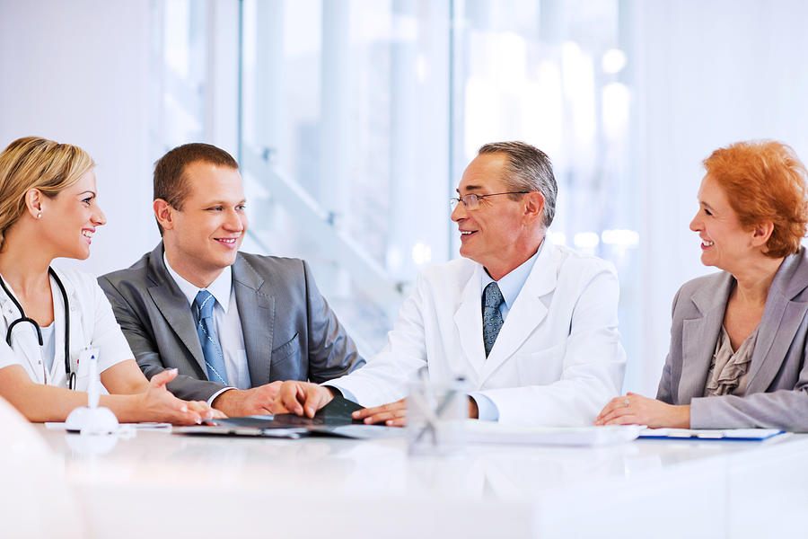 Doctor Collaborating with a Business Team Photograph by Skynesher