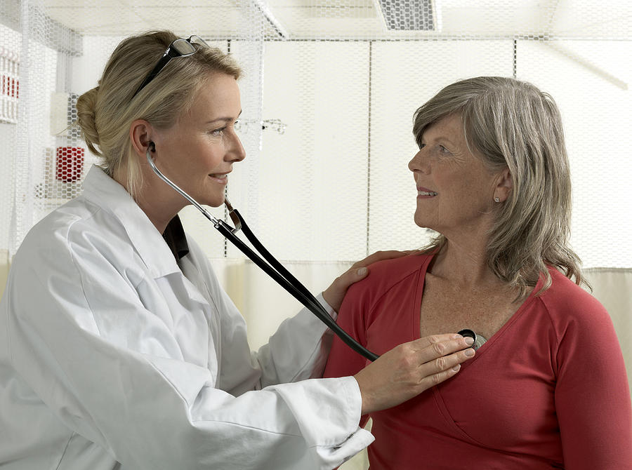 Doctor examining mature woman Photograph by Jonatan Fernstrom