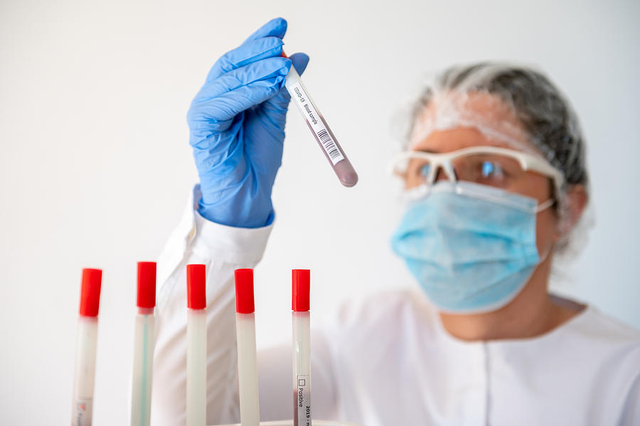 Doctor holding Coronavirus test tube Photograph by Stefan Cristian Cioata