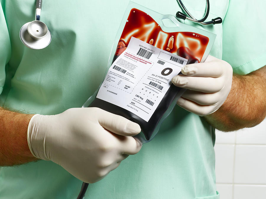 Doctor/ Nurse holding blood bag. Photograph by Peter Dazeley