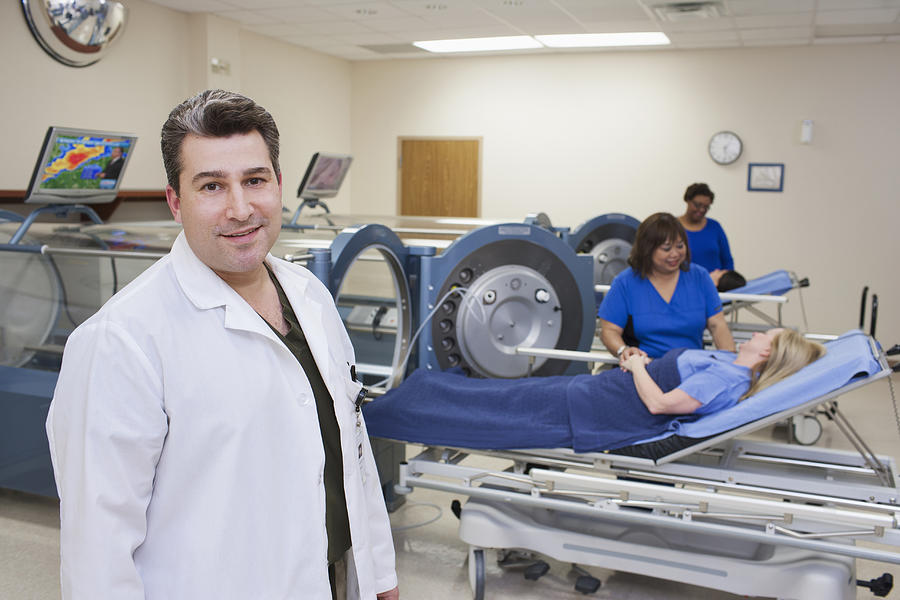 Doctor standing in hyperbaric chamber room Photograph by ER Productions Limited