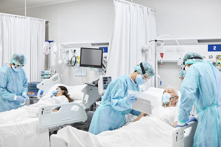 Doctors and Nurses Taking Care of Patients in ICU Photograph by Morsa Images