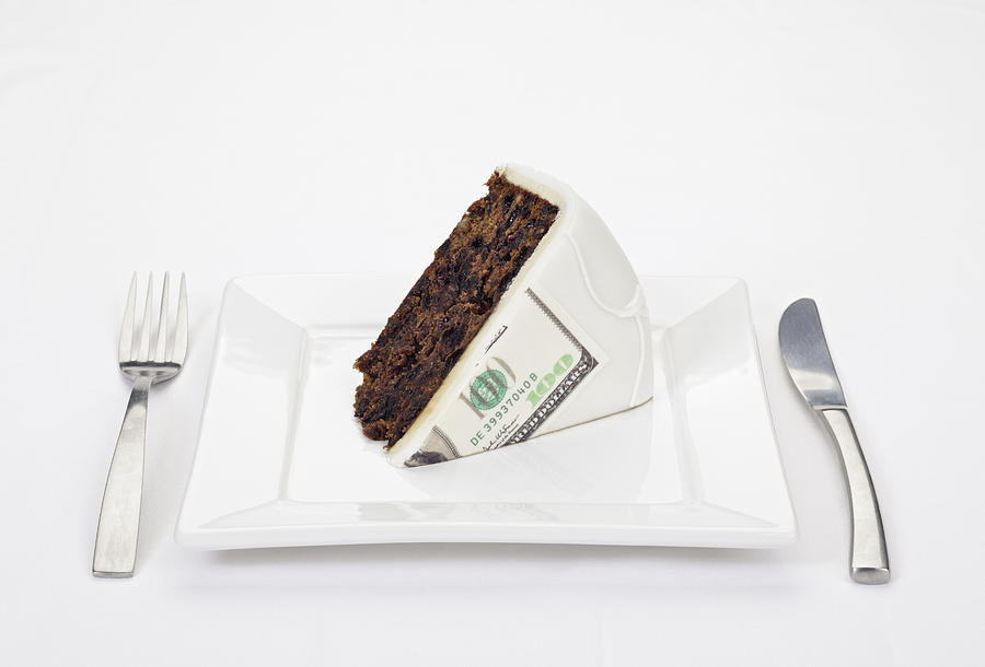 Dollar bill printed on slice of cake Photograph by Photo_Concepts